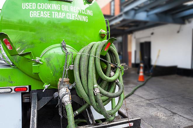 grease trap pumping truck servicing a restaurant in Auburndale